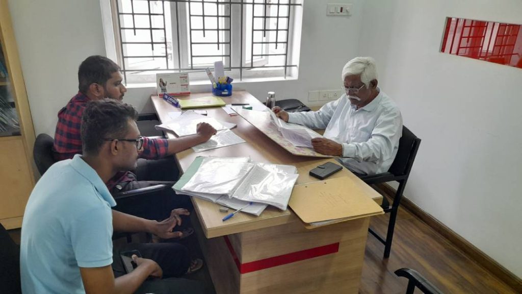 Col P JEYARAJ (Retd) Director & Chief Trainer view the student form in front of the two students