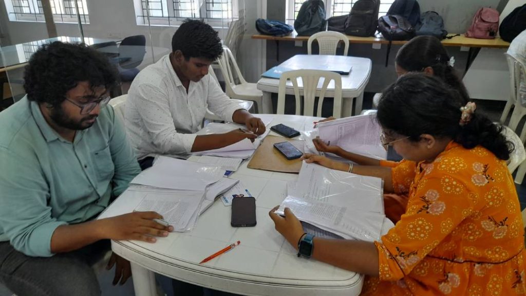 Four students to sit the chair to see the study materials